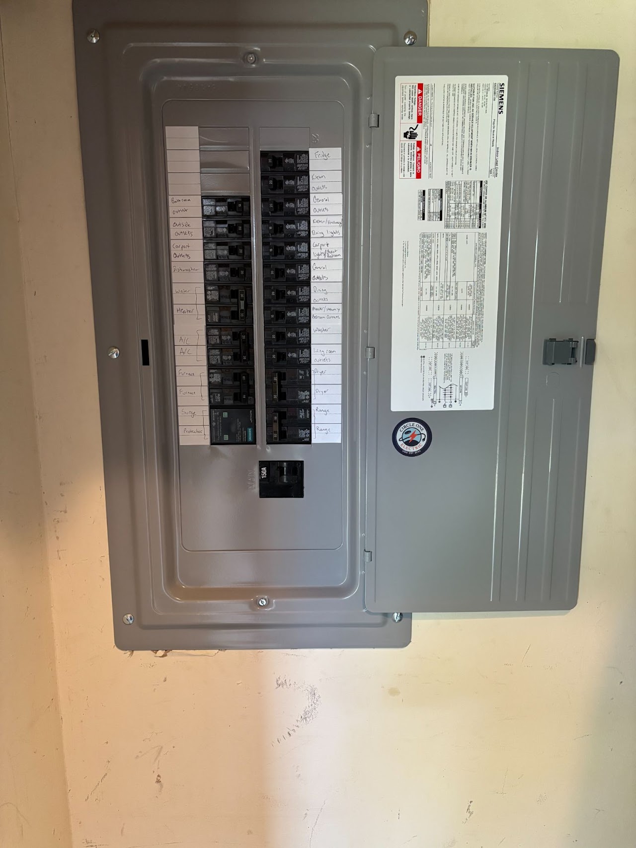 Finished panel with neatly labeled circuits and a Circle One Electric sticker on the door